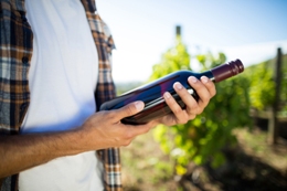 man holding wine bottle