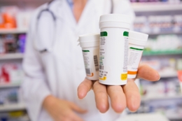 pharmacist holding medications