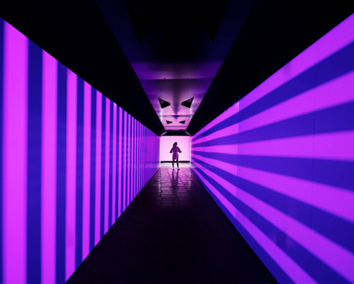 Person at the end of an illuminated tunnel
