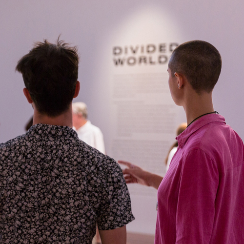 Close up on back view of two people engaging with an installation at Samstag Museum of Art.