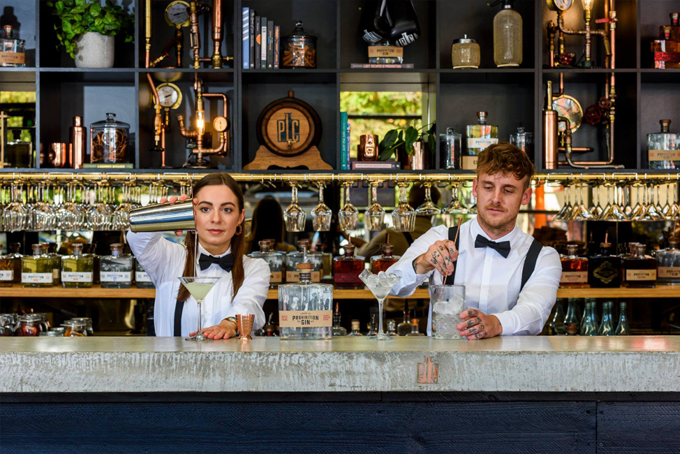 Appropriately styled bar staff serving gin out of the Prohibition Liquor Co. bar on Gilbert Street.