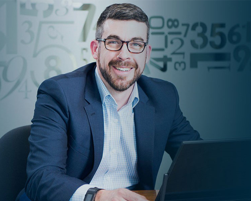 Man with lap-top in front of digital symbol background