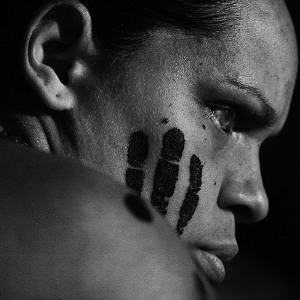 An aboriginal woman with a hand print on her face