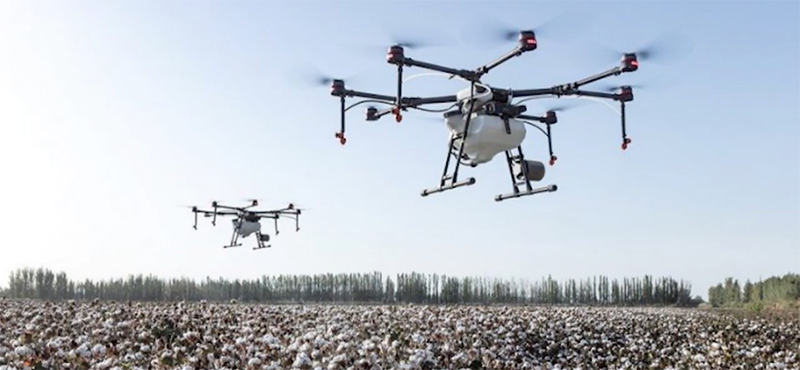 Drones flying over a field