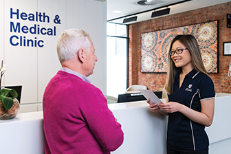 A student speaking to a patient in UniSA's health clinic