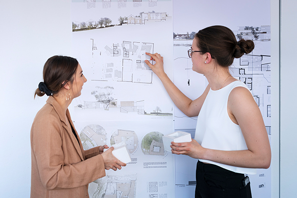 Two people in front of a whiteboard