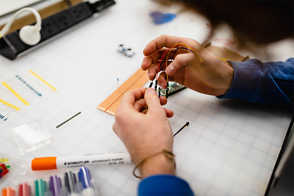 Hands working on electronics