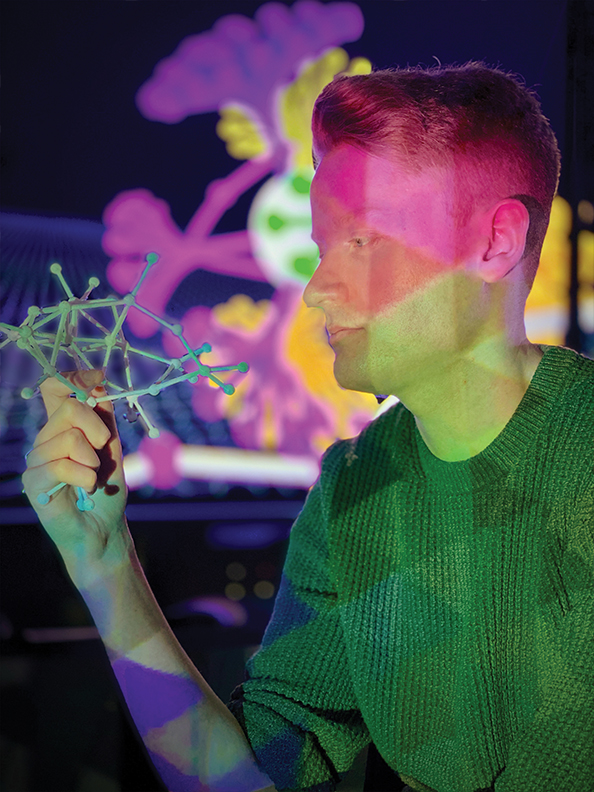 A researcher examining a model of a molecule