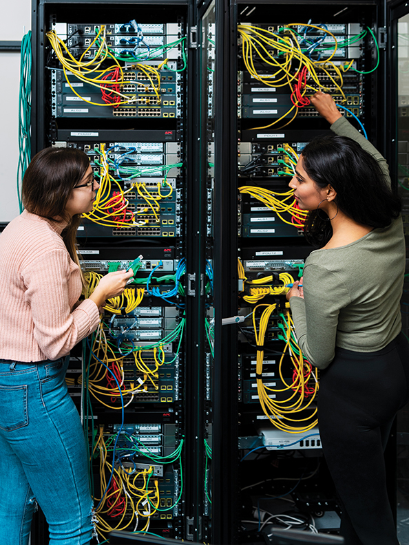 Two students working with a computer server