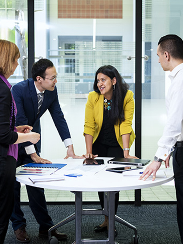 A group of people meeting around a table