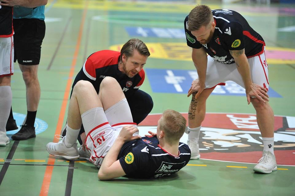 Valgeir (left) as Head Physiotherapist treating a player on court during a game. 