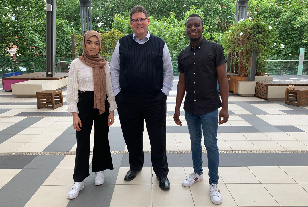 Professor Nicholas Procter with two UniSA students from refugee communities