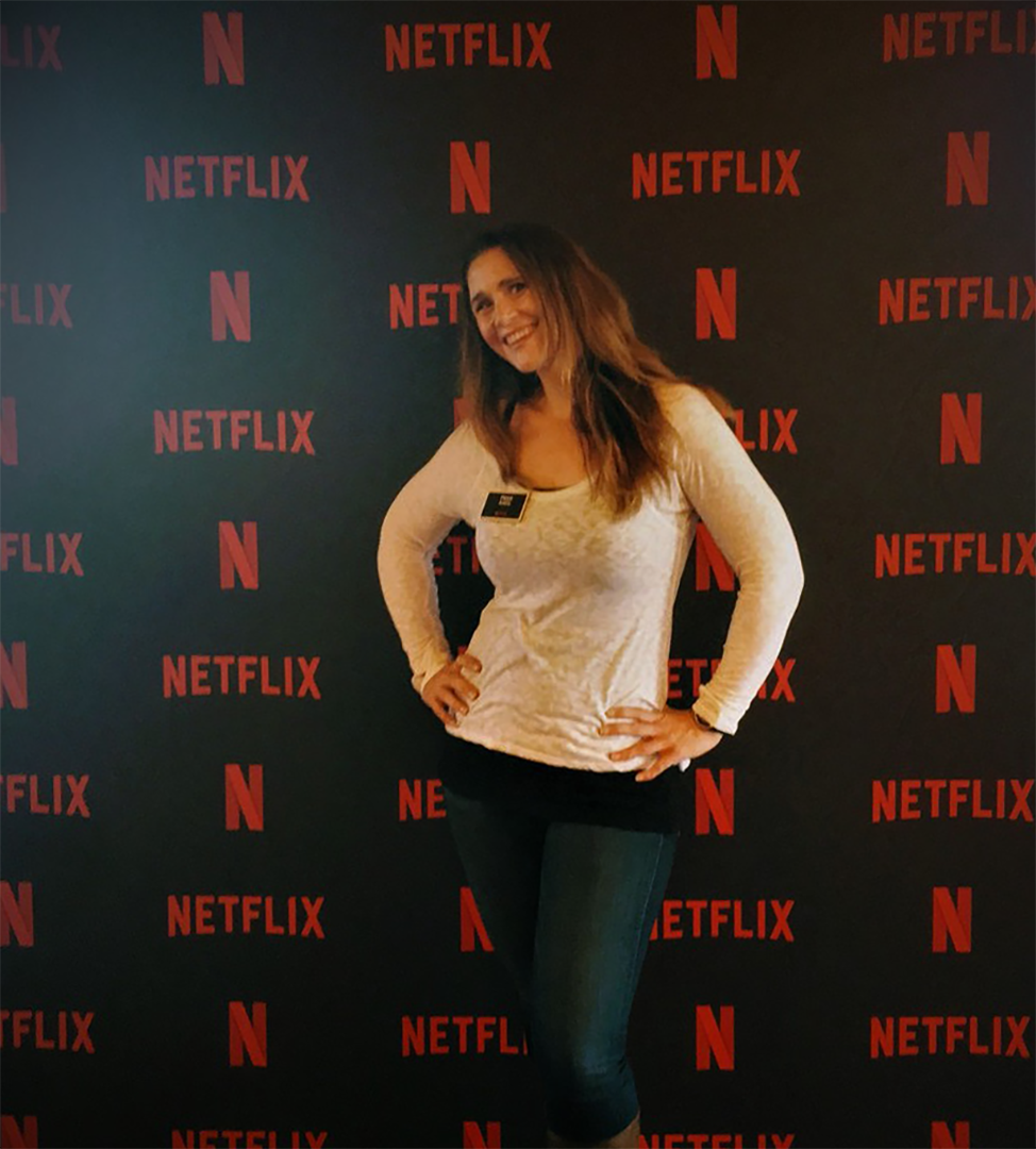 Phillipa Avery standing in front of a Netflix media screen