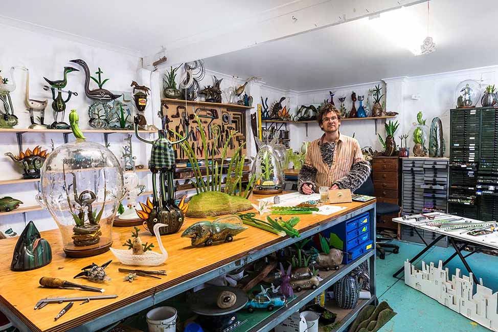 Tom Moore in his studio, surrounded by his fantastical creations. 