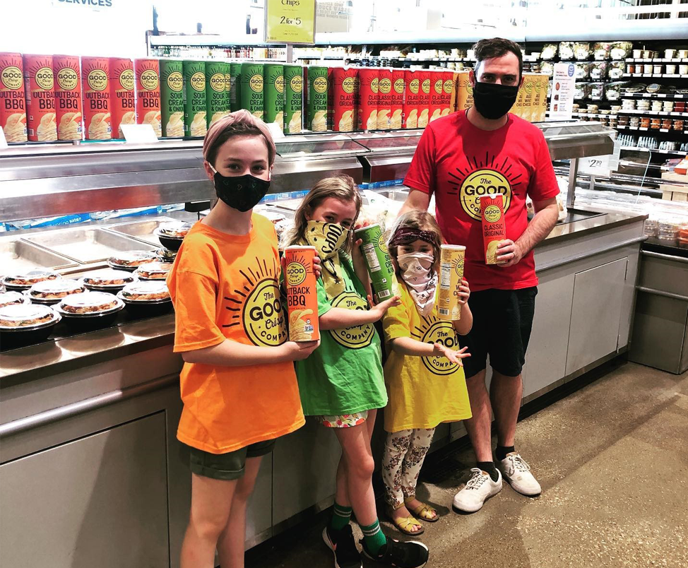 Matt Parry and his children in a supermarket holding The Good Crisp Company potato crisps