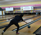 Bowler throwing ball down the alley