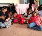 Malaysia Alumni Chapter member playing with orphans at Rumah Juara