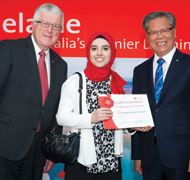 Huda Nabeel Dawood Kharrufa (middle) receiving heraward from Chair of StudyAdelaide Bill Spurr (left) and His Excellency the Honourable Mr Hieu Van Le, Governor of South Australia.