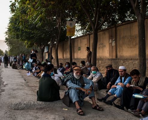 Photography, Andrew Quilty. People queue at sunrise outside Afghanistan's only passport office in July 2021.  As many as 5,000 passports were being issued daily, as Afghans from across the country, many fearing a country-wide return of the Taliban, travelled to the capital to apply for passports in the hope of using them to travel outside the country. 