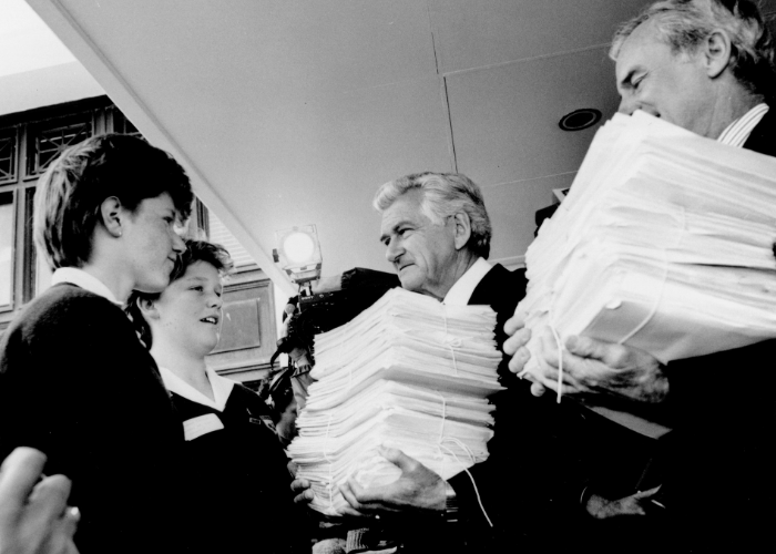 Image: Children presenting a petition to Prime Minster, Bob Hawke outside Parliament House in Canberra, 20 November 1986 (NAA: A6180, 20/11/86/4). Image courtesy of the National Archives of Australia, digitised from photographs in the Bob Hawke Collection.