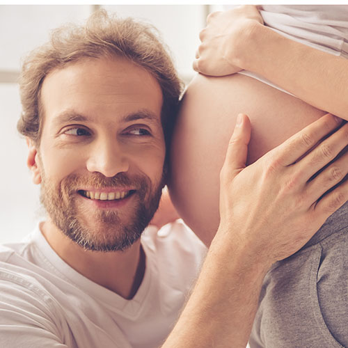 Dad hugging pregnant belly