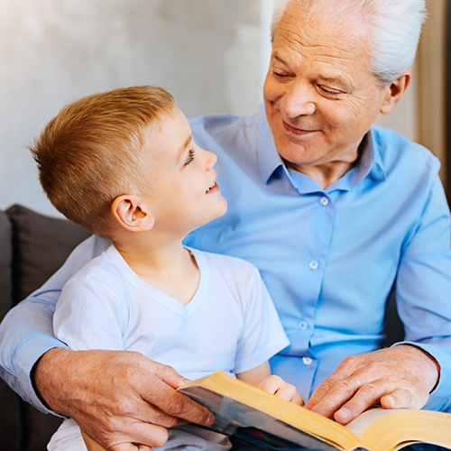 preschooler and grandparent reading together