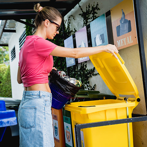 Person putting rubbish into bin