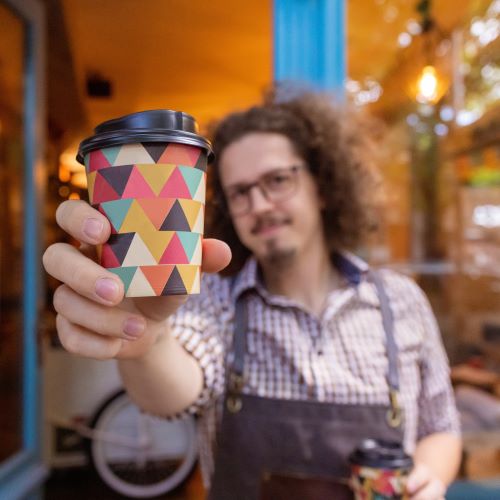 A barista with a coffee cup