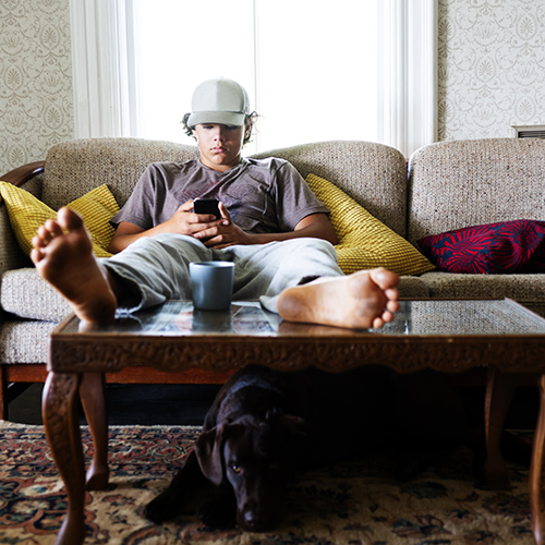 teenager on couch with phone