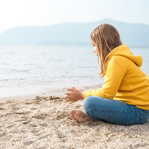 pensive teenager on beach - shutterstock_2320561749_web.jpg