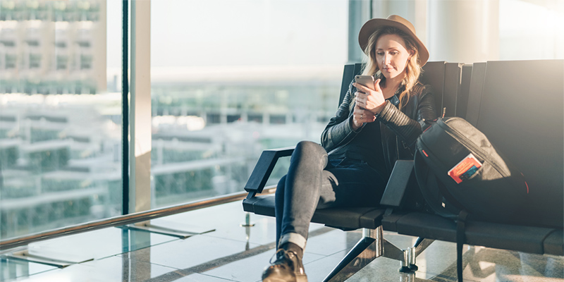 Woman using free wifi at the airport