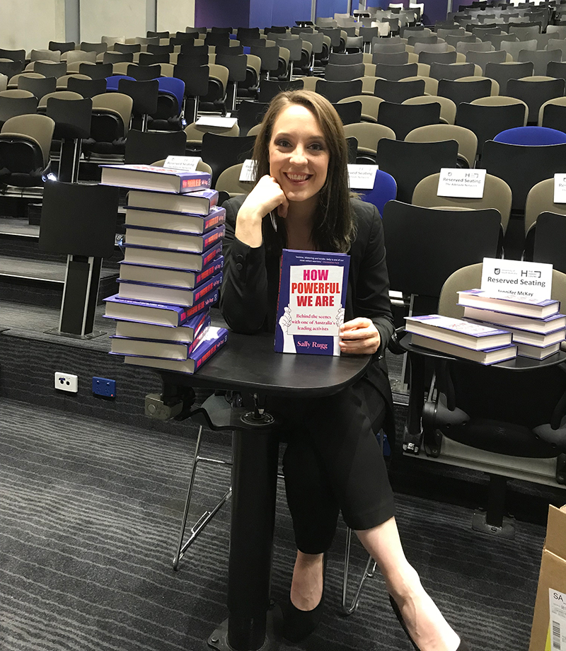 Sally Rugg with a copy of her book