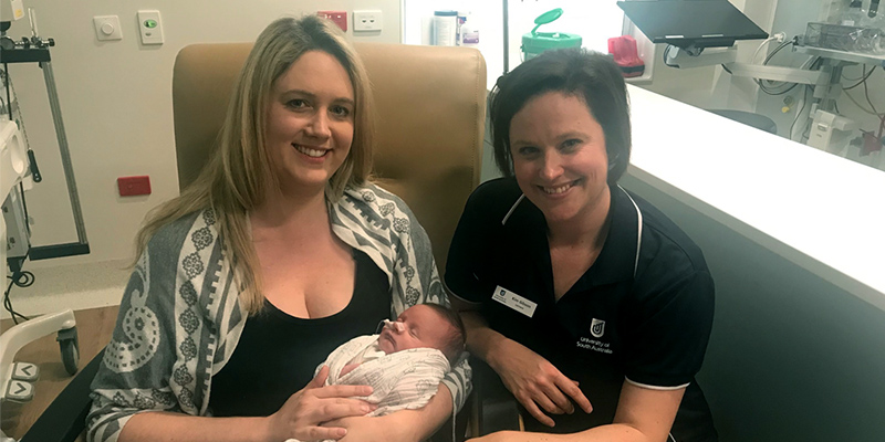 UniSA clinical care specialist Kim Gibson pictured with mum Sarah Sheil and her premature baby Toby at Flinders Neonatal Care Unit.