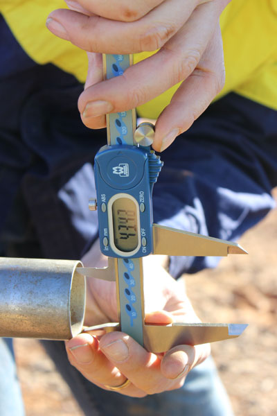 A coated sample tube, from the inside of a drill system used in mining, being checked for wear. Photo by Juan van Staden.