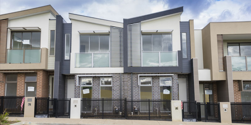 Newly built contemporary townhouses. Photo: Sunflowerey / Shutterstock.com