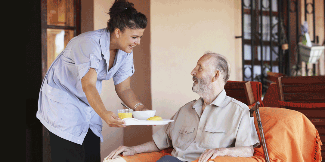 man receiving meal in a nursing home