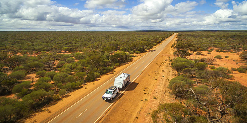 A car and campervan on dirt road