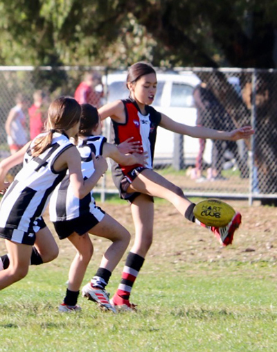 Active Indigenous kids kicking on at school.