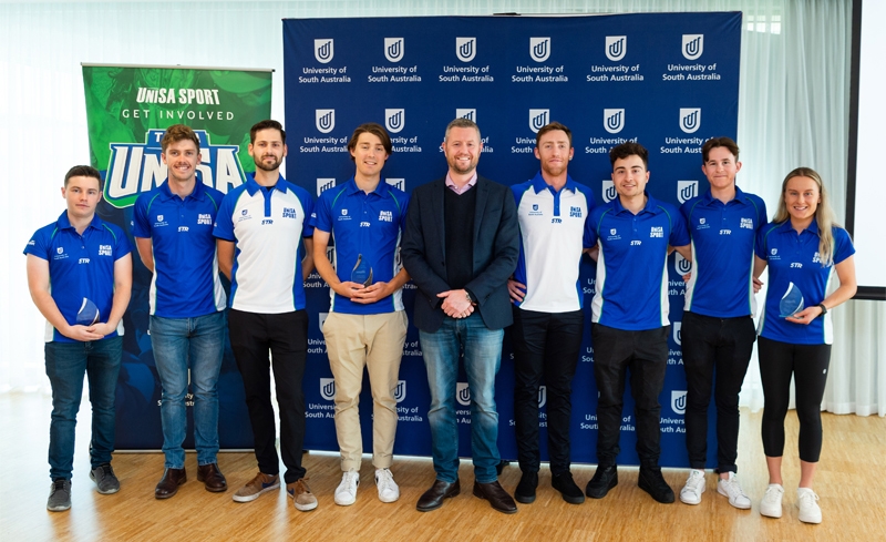 (L-R) Dougy Howard, Cooper Sayers, Ryan Brown, Callum Pearce, Vice Chancellor Professor David Lloyd, Rylan Dowdell, Liam Lawlor, Daniel Siwek and Caitlin Adams.