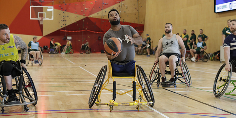 Soraj Habib going for goal while Invictus Pathways Program participants watch on at the 2021 Invictus Games team camp, held in UniSA's Pridham Hall.
