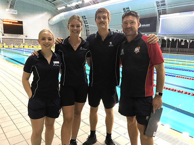 UniSA students Leanna Steed, Cat Wojcik and Jacob Sloane with swimming convener Jared King.