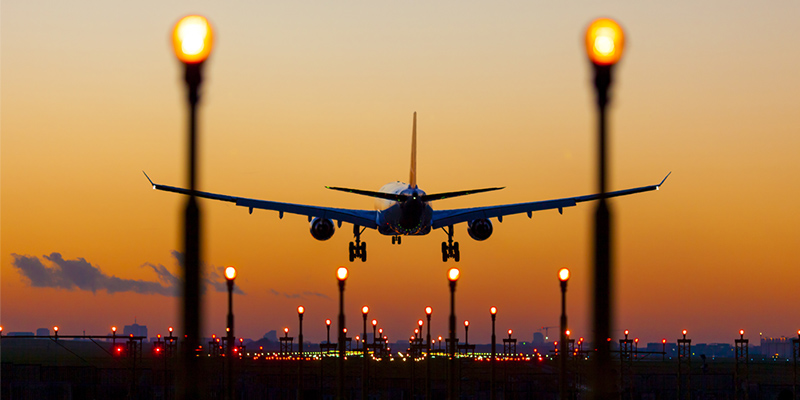 airplane landing at sunset