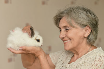 Aged care resident with her pet rabbit