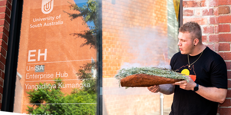 Kaurna and Ngarrindjeri man Isaac Hannam performs a smoking ceremony for the UniSA Enterprise Hub.