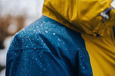 On a hydrophobic material such as a rain jacket, water will bead into droplets.