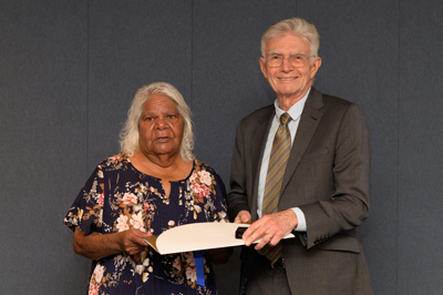 Judy Johnson receiving Kelvin W Johnson’s posthumous award from UniSA Chancellor John Hill.